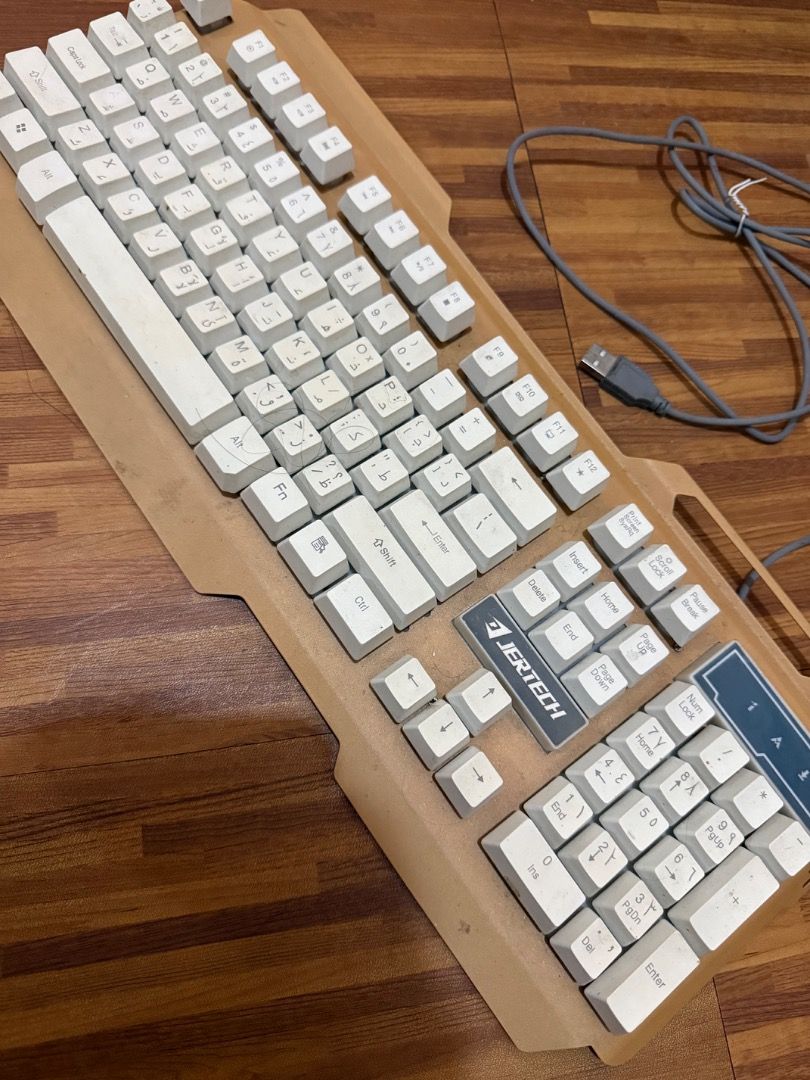 Gaming Keyboard Jertech (Category: Mouse & Mousepads) located in Manila. Submitted by affordshopz (Listing ID 1453158453, Image 1). Description: This keyboard features a unique, angular ergonomic frame that provides great wrist support for long typing or gaming sessions. It has been thoroughly tested, cleaned, and is ready for its next owner. Key Features: Dual Layout: Features standard English QWERTY letters alongside printed Korean (Hangul) cha