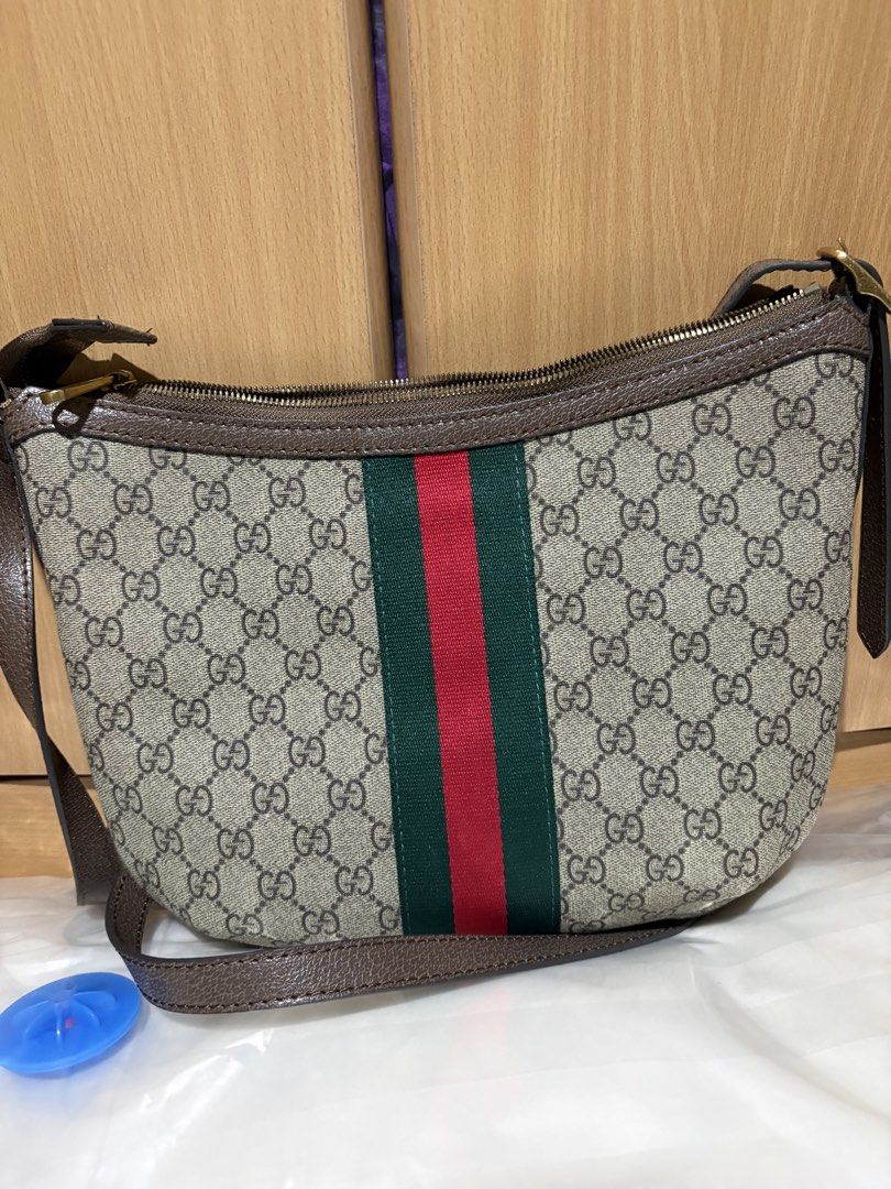 Gucci Monogram Shoulder Bag with Green and Red Stripe (Category: Luxury Bags & Wallets) located in Pateros City. Submitted by fatkat109 (Listing ID 1453085894, Image 2). Description: - Classic Gucci monogram shoulder bag - Iconic GG logo - Signature green and red stripe - Leather trim and strap - Zipper closure - Gold-tone hardware - Timeless addition to your collection Issues: - faint stain on the interior, near zipper.