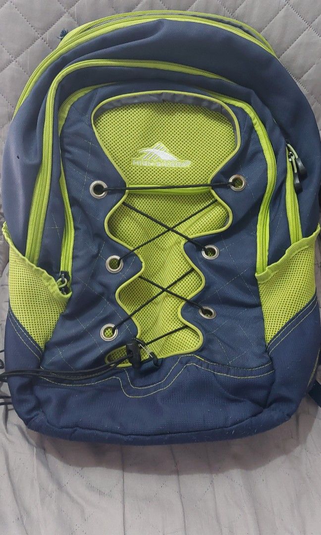 High Sierra Backpack (Category: Backpacks) located in Pasig City. Submitted by toydaddyph (Listing ID 1453134931, Image 1). Description: Item is an original pre-owned High Sierra multi-compartment sports backpack featuring a prominent front bungee storage system. The bag uses a contrasting two-tone color scheme with dark blue panels and vibrant neon green mesh fabric accents. It has an approximate capacity of 33 L. It is built with water-resistan