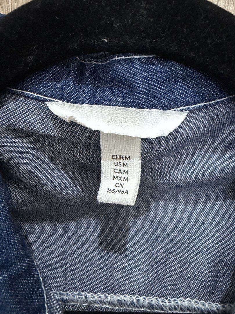 H&M Denim Shirt with White Trim (Category: Shirts) located in Quezon City. Submitted by aleeya23 (Listing ID 1453055970, Image 3). Description: - H&M Blue Denim Shirt - Size: Medium (M) - White scalloped trim along buttons and cuffs - Single chest pocket - Classic button-up style .