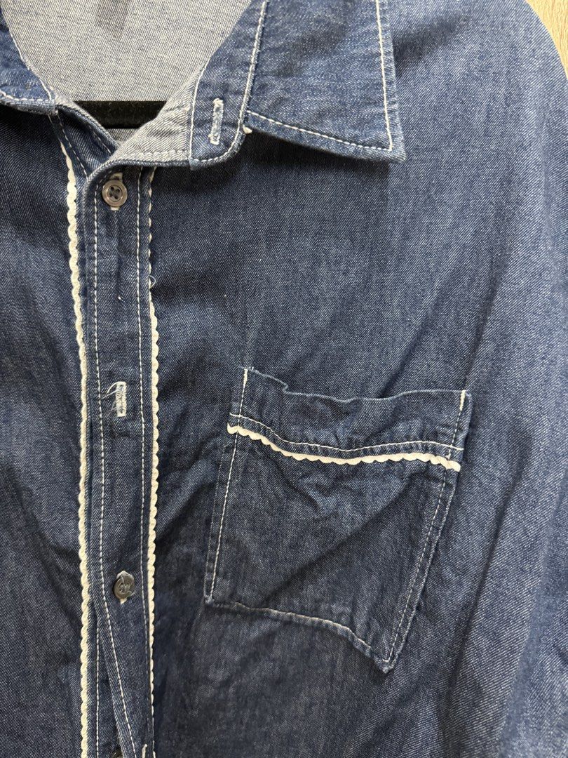 H&M Denim Shirt with White Trim (Category: Shirts) located in Quezon City. Submitted by aleeya23 (Listing ID 1453055970, Image 2). Description: - H&M Blue Denim Shirt - Size: Medium (M) - White scalloped trim along buttons and cuffs - Single chest pocket - Classic button-up style .