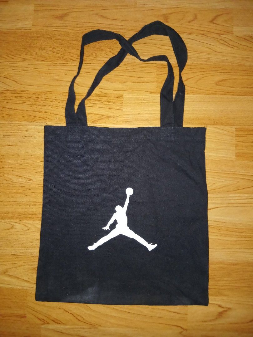 Jordan Jumpman Black Canvas Tote Bag (Category: Tote Bags) located in General Santos City (Dadiangas). Submitted by afsph1996 (Listing ID 1453144845, Image 3). Description: - Classic black canvas tote bag - Features the iconic Jumpman logo on one side - 'JUMPMAN.' text on the other side - Simple, durable, and perfect for everyday use - Spacious enough to carry all your essentials.