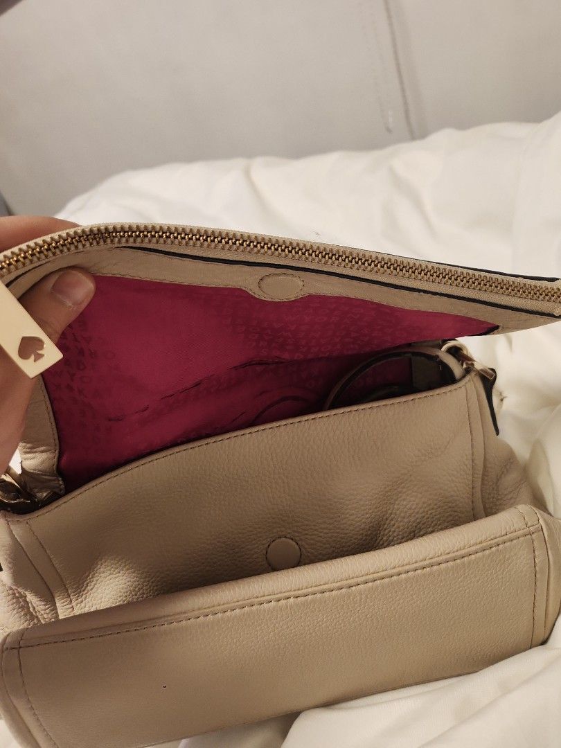 Kate Spade Beige Leather Handbag with Pink Interior (Category: Luxury Bags & Wallets) located in Valenzuela. Submitted by jochaaa011 (Listing ID 1453201269, Image 2). Description: - Brand: Kate Spade - Color: Beige exterior, bright pink interior with signature print - Material: Genuine Leather - Closure: Zipper - Condition: Exterior leather shows some wear, particularly on straps. Interior lining has marks and scuffs. - Style: Perfect for everyda