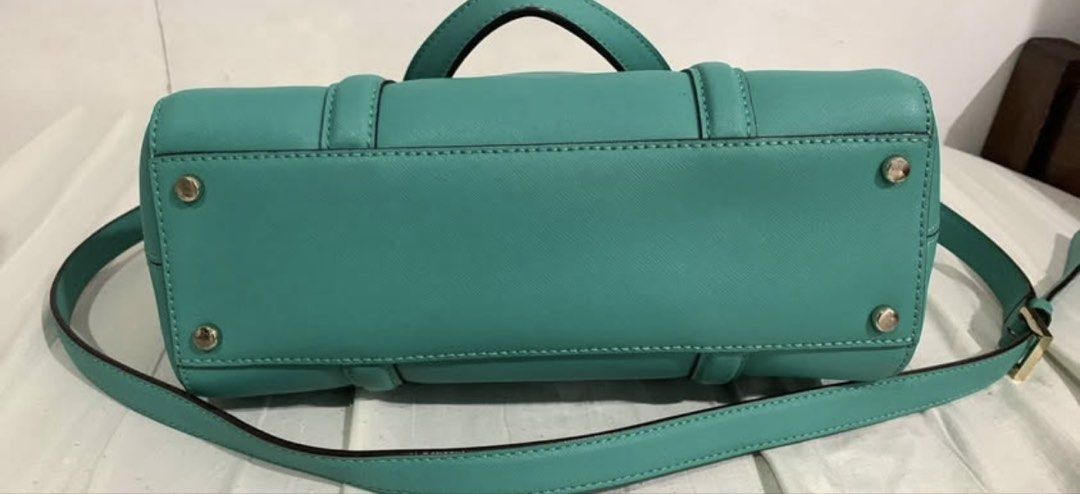 Kate Spade Teal Leather Satchel Handbag (Category: Clutches) located in Manila. Submitted by DECLUTTERWITHADA (Listing ID 1453146810, Image 2). Description: - Authentic Kate Spade teal leather satchel - Elegant gold hardware details - Versatile carrying options: top handles and detachable crossbody strap - Secure zipper closure - Interior features a stylish patterned lining - Ample space for all your essentials - Ideal for everyday wear and styli