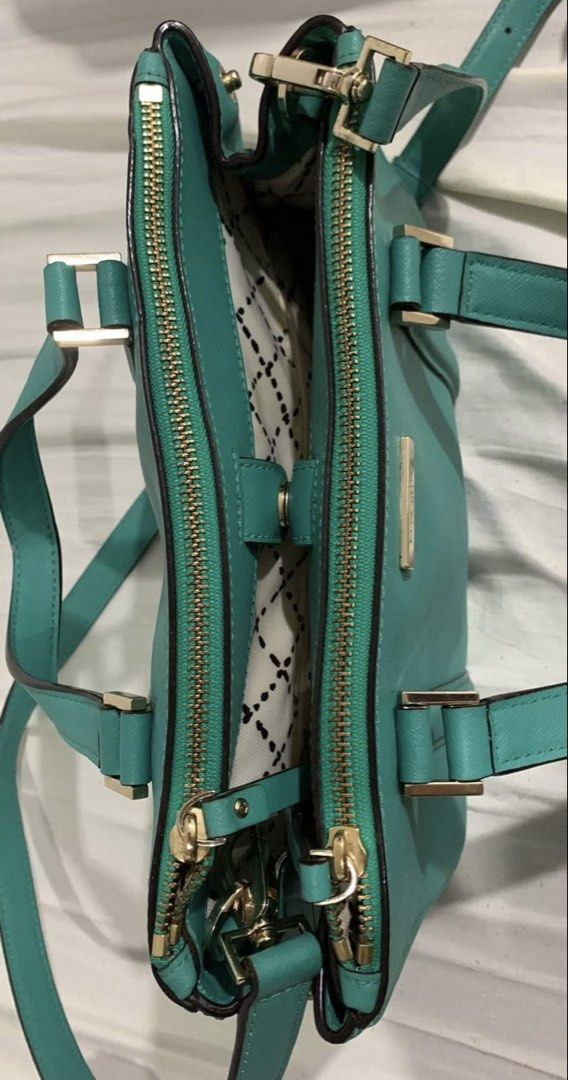 Kate Spade Teal Leather Satchel Handbag (Category: Clutches) located in Manila. Submitted by DECLUTTERWITHADA (Listing ID 1453146810, Image 3). Description: - Authentic Kate Spade teal leather satchel - Elegant gold hardware details - Versatile carrying options: top handles and detachable crossbody strap - Secure zipper closure - Interior features a stylish patterned lining - Ample space for all your essentials - Ideal for everyday wear and styli
