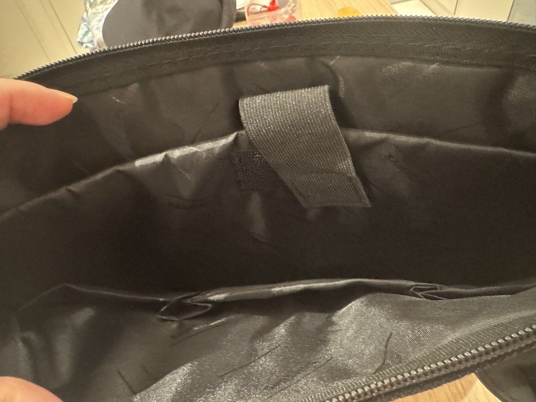Laptop bag (Category: Briefcases) located in Quezon City. Submitted by tinylee60 (Listing ID 1453098288, Image 3). Description: - Durable black nylon construction - Elegant leather handles and trim - Convenient front zip pocket with metal logo plate - Spacious main compartment with internal organization pockets - Includes a detachable shoulder strap for versatile carrying - Ideal for professional use or travel Size 11” x 16” x3”depth .