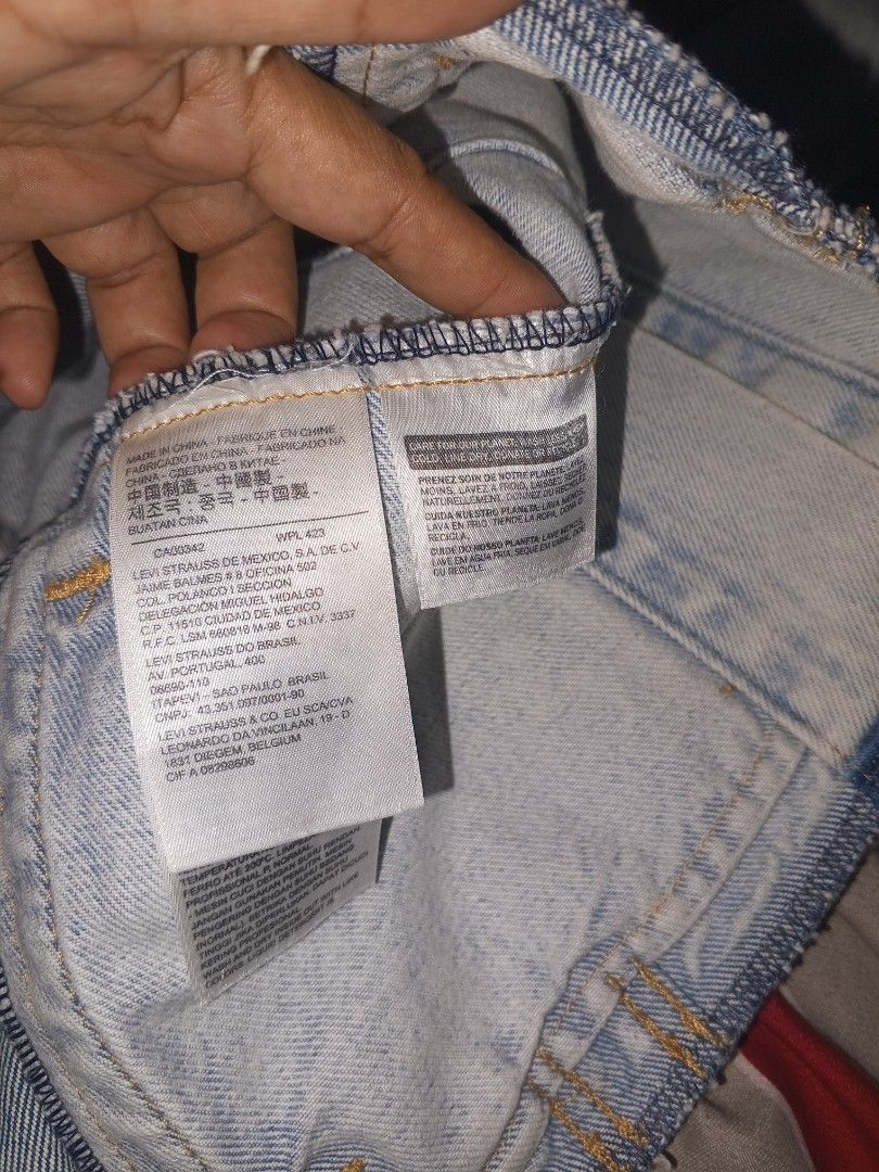 Levi's Denim Jacket Size M - Patchwork Design (Category: Coats, Jackets and Outerwear) located in Magalang. Submitted by zeiansoria64090 (Listing ID 1453145492, Image 3). Description: - Classic Levi's denim jacket - Size: Medium (M) - Unique patchwork design with light and dark blue denim panels - Button-up front closure - Two chest pockets - Ideal for layering over outfits -issue minimal stains and cut sa baba.