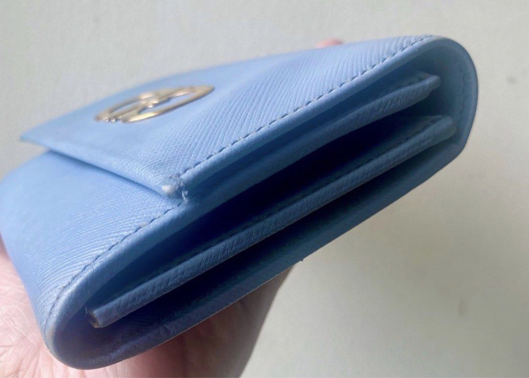 Ferragamo Wallet (Category: Luxury Bags & Wallets) located in Mandaluyong City. Submitted by mthjaps (Listing ID 1453196738, Image 3). Description: Authentic. Light blue wallet with a gold logo hardware. Shows minor signs of wear. Stored most of the time (excellent condition). With Multiple compartments visible. Wallet only.