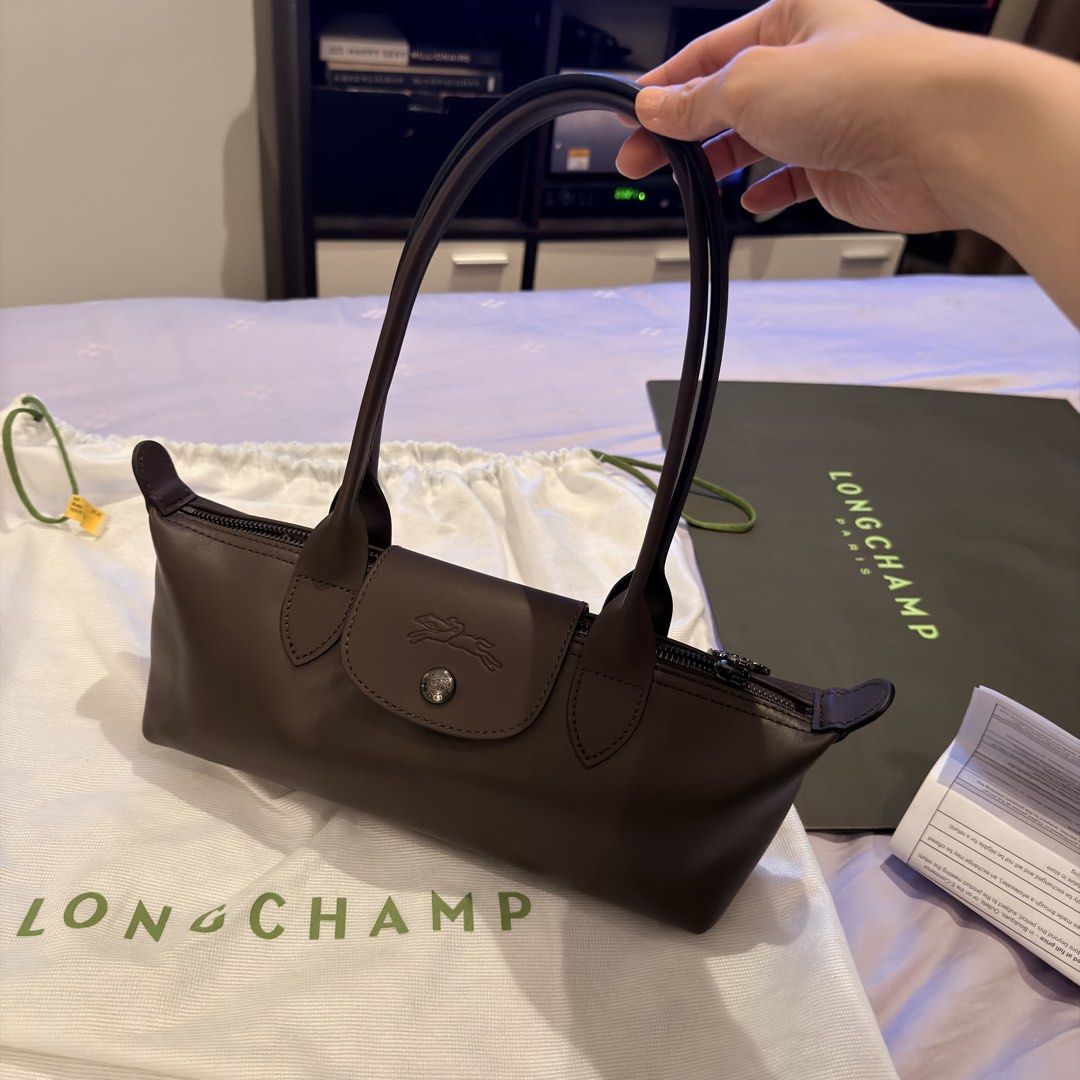 Longchamp Le Pliage Shoulder Bag (Category: Luxury Bags & Wallets) located in Makati City. Submitted by kcouture (Listing ID 1453228324, Image 1). Description: - Authentic Longchamp Le Pliage shoulder bag - Color: Dark Brown - Authenticity guaranteed: Purchased from ION Orchard - Includes original dust bag, paper bag, and receipt - Ideal for everyday use - Selling because I have too many bags.