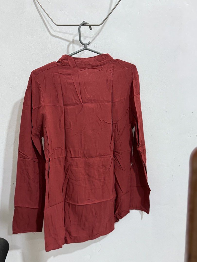 Maroon Long Sleeve Top with Cut-out Neckline (Category: Longsleeves) located in Manila. Submitted by acluttering (Listing ID 1453167080, Image 3). Description: - Chic maroon long-sleeved top - Features a stylish neckline cut-out with button closure - Textured, slightly crinkled fabric - Relaxed fit for ultimate comfort - Versatile for casual outfits, pairs well with jeans or skirts.