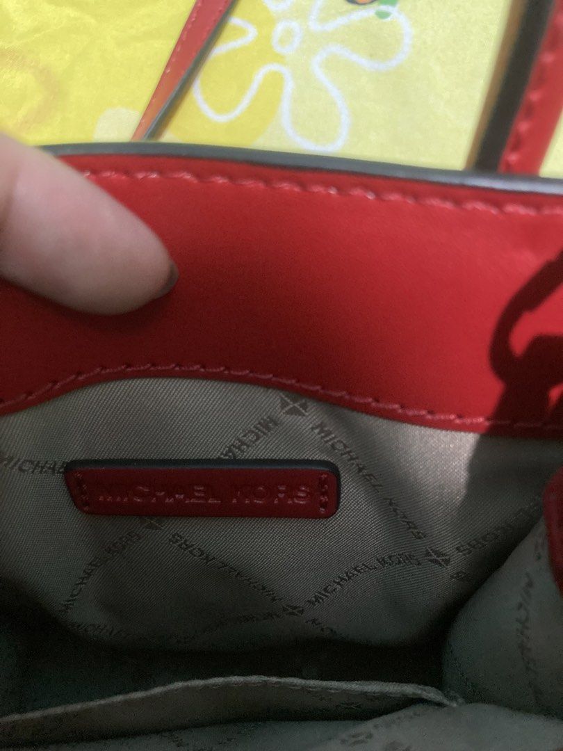 Michael Kors Red Leather Small Handbag (Category: Luxury Bags & Wallets) located in Batangas. Submitted by jaine0731 (Listing ID 1453167766, Image 3). Description: - Authentic Red Michael Kors handbag - Made from premium pebbled leather - Features a signature gold MK logo charm - Includes a detachable strap for versatile carrying options - Interior showcases Michael Kors branding - Ideal size for carrying your daily essentials.