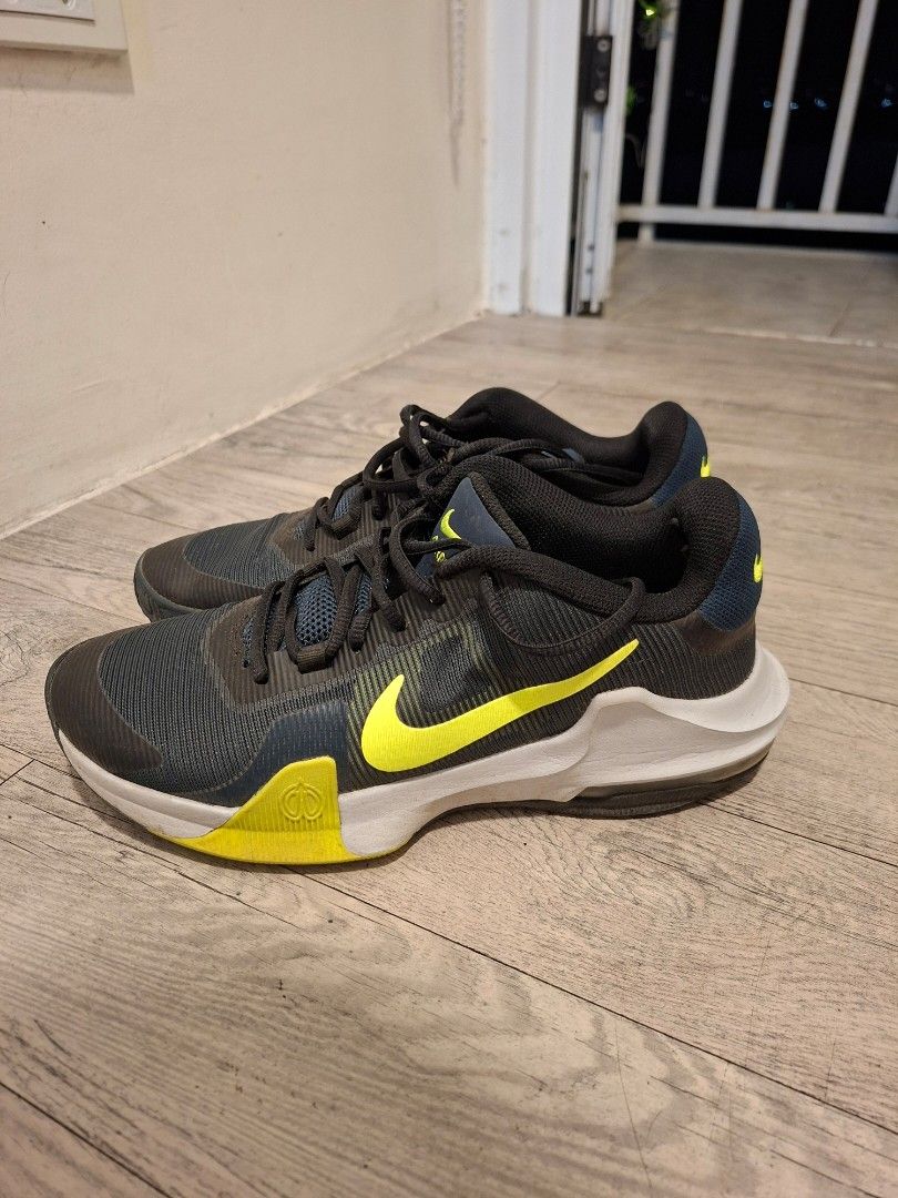 Nike Air Max Men's Running Shoes (Category: Sneakers) located in Pasig City. Submitted by avcan (Listing ID 1453176793, Image 2). Description: - Nike Air Max shoes - Color: Dark grey with bright yellow accents - Closure: Lace-up - Ideal for: Running or training - Sole condition: Shows some wear, but still offers plenty of grip - Please check photos for detailed condition.