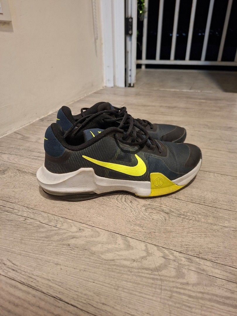 Nike Air Max Men's Running Shoes (Category: Sneakers) located in Pasig City. Submitted by avcan (Listing ID 1453176793, Image 3). Description: - Nike Air Max shoes - Color: Dark grey with bright yellow accents - Closure: Lace-up - Ideal for: Running or training - Sole condition: Shows some wear, but still offers plenty of grip - Please check photos for detailed condition.