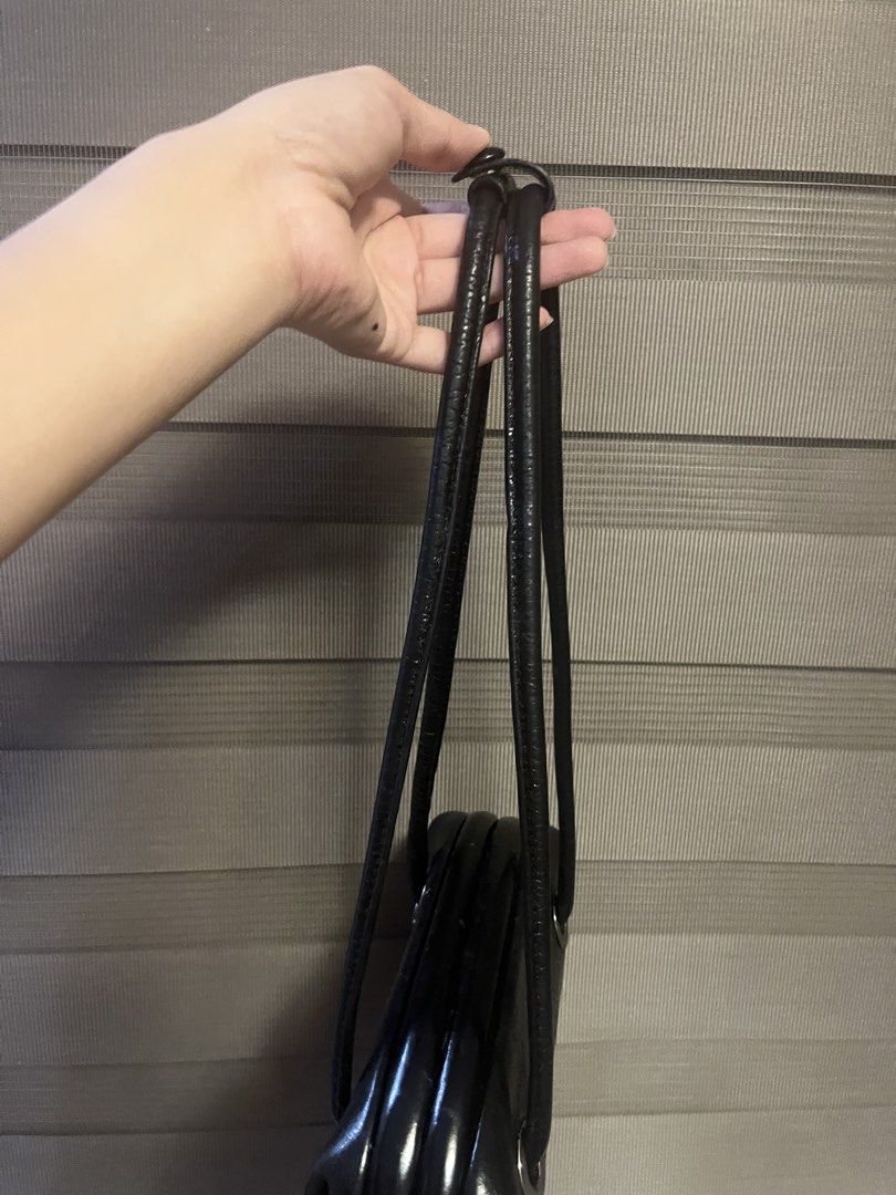 Osoi Black Patent Leather Shoulder Bag with Silver Hardware (Category: Shoulder Bags) located in Plaridel. Submitted by rarefindlux (Listing ID 1453128686, Image 3). Description: - Black patent leather shoulder bag - Shiny, glossy finish - Silver hardware details on the front - Classic, versatile shape - Thin, comfortable leather straps - Black fabric interior with a small pocket.