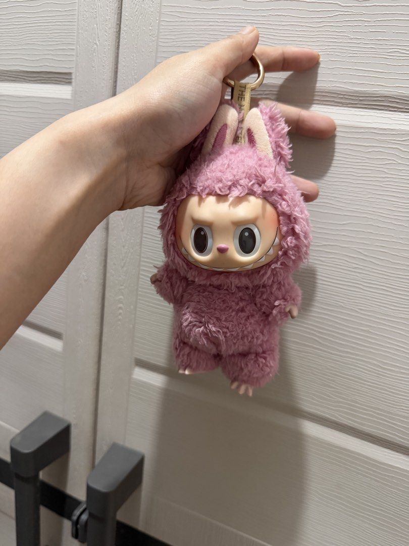 Pink Labubu( original) (Category: Plushies & Soft Toys) located in Davao. Submitted by fabdeclutter (Listing ID 1453234826, Image 2). Description: - Adorable pink fluffy monster toy - Features cute bunny ears and a big smile - Includes a keychain attachment - Ideal for decorating bags or keys - A fun and unique collectible item.