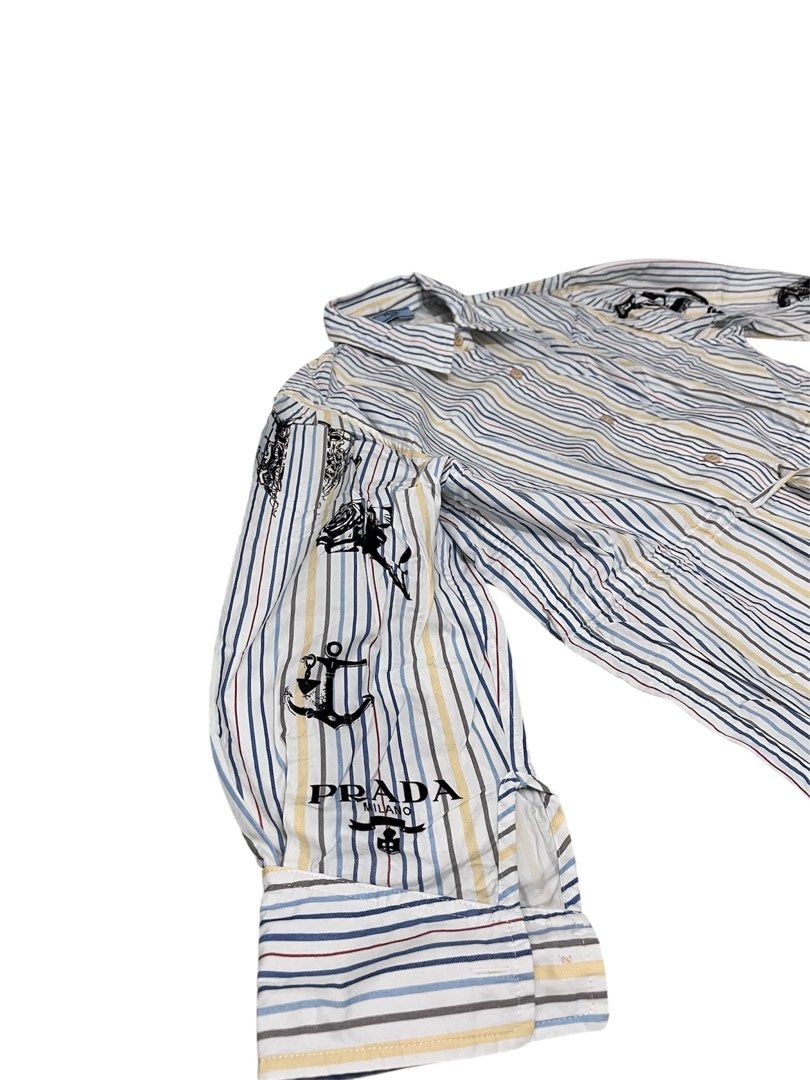 Prada Striped Poplin Shirt Graphic Print (Category: Luxury Apparel) located in Dumaguete. Submitted by overthrifted (Listing ID 1453168428, Image 3). Description: 20 chest width 19 waist width . 27 length - Features unique graphic prints on sleeves (owls & anchors). - Adjustable drawstring waist for a customized fit for womens - Versatile for casual or statement styling..