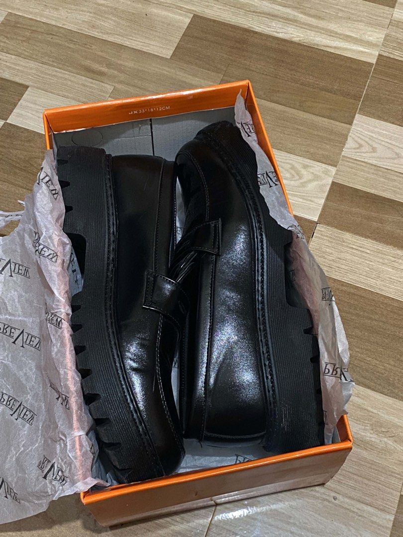 PREVIEW Black Chunky Sole Loafers (Category: Casual Shoes) located in Manila. Submitted by johnmycoan83974 (Listing ID 1453175747, Image 3). Description: - Classic black penny loafers - Chunky sole for a modern look - Includes original box and tissue paper - Perfect for dressing up or down - Comfortable and stylish for everyday wear.