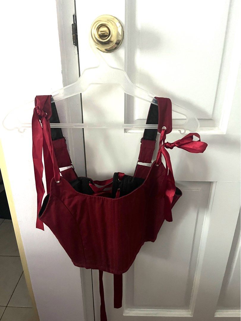 Red Corset Top with Premium Ribbon Ties (Category: Sleeveless) located in Mandaluyong City. Submitted by maesim (Listing ID 1453068917, Image 1). Description: - Stunning red corset top - Satin-like material for a luxurious look - Adjustable ribbon ties at shoulders and back for a custom fit - Lace-up front detail for a classic corset style - Flattering design that enhances your shape - Versatile piece for outfits or costumes.