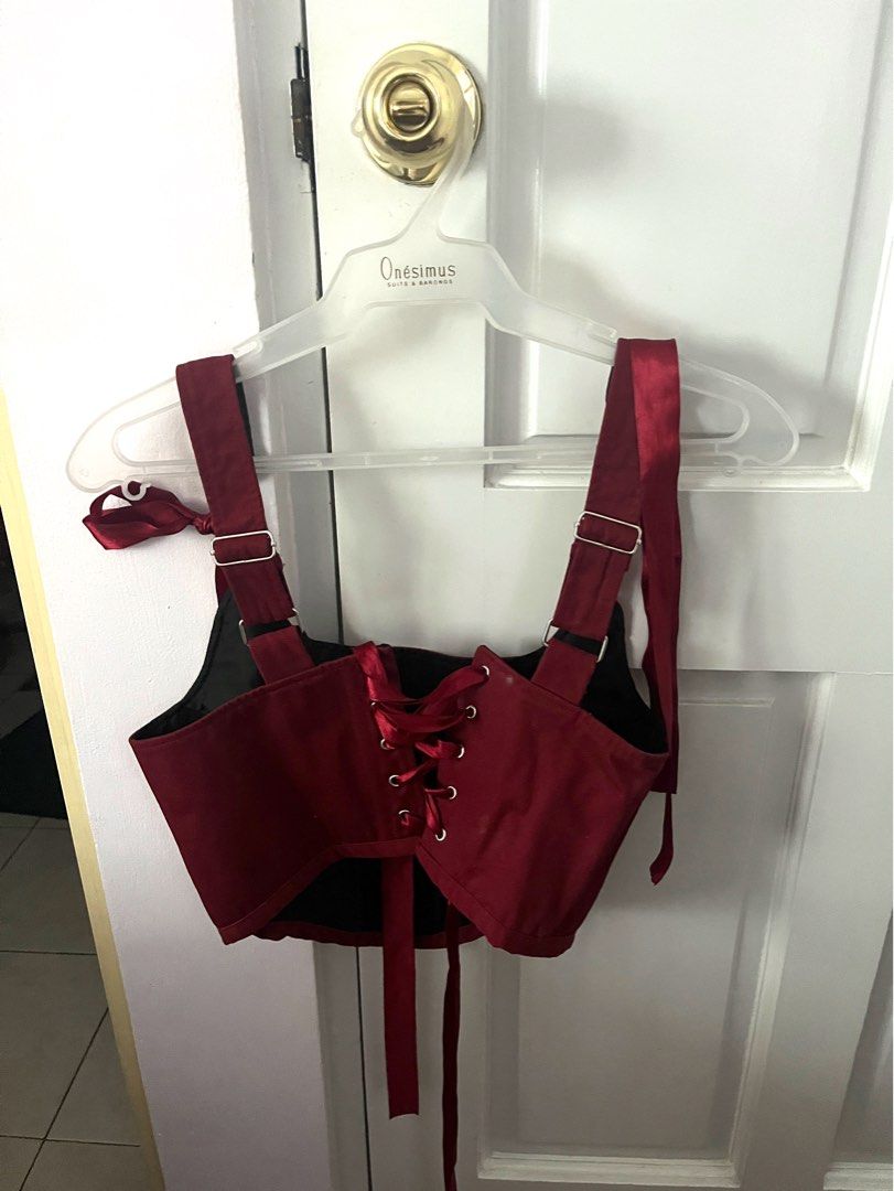 Red Corset Top with Premium Ribbon Ties (Category: Sleeveless) located in Mandaluyong City. Submitted by maesim (Listing ID 1453068917, Image 2). Description: - Stunning red corset top - Satin-like material for a luxurious look - Adjustable ribbon ties at shoulders and back for a custom fit - Lace-up front detail for a classic corset style - Flattering design that enhances your shape - Versatile piece for outfits or costumes.