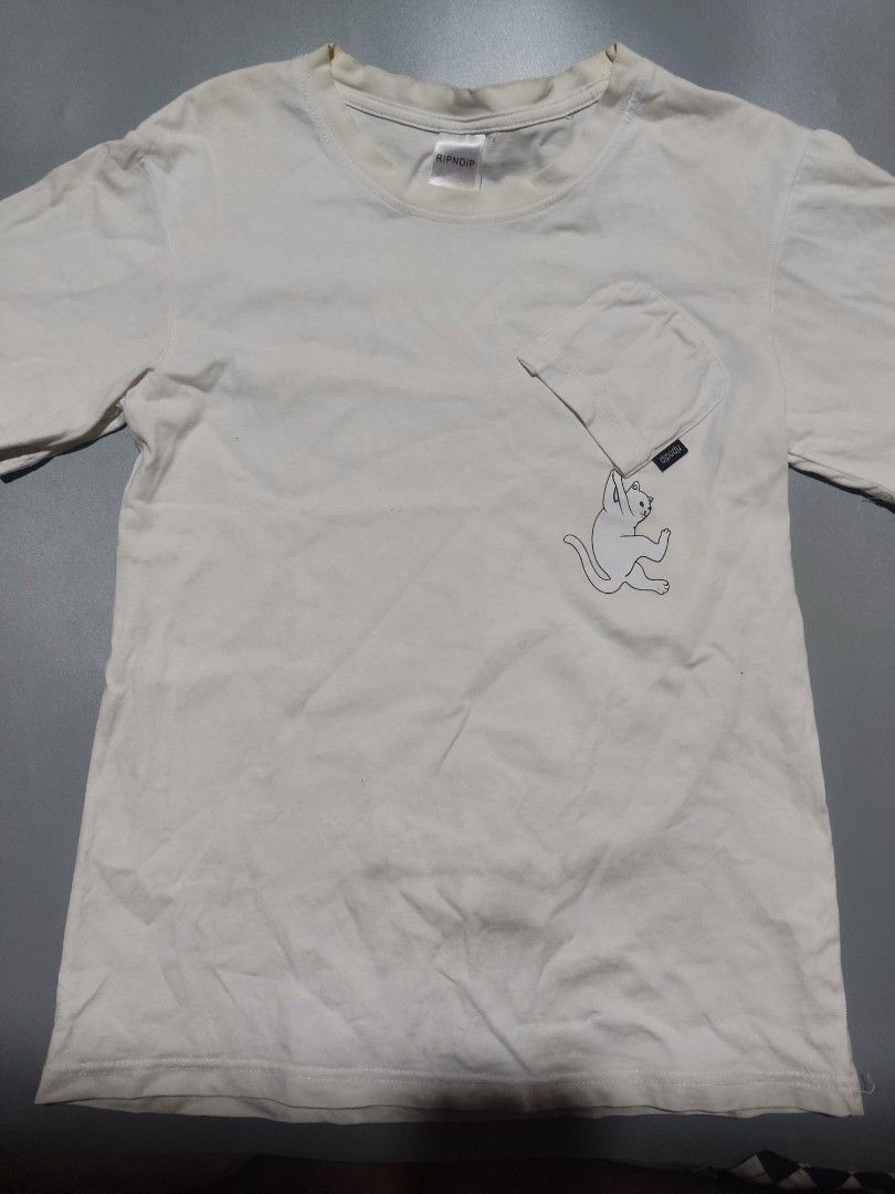 RIPNDIP White Pocket T-Shirt (Category: Activewear) located in Pasig City. Submitted by tobyrama (Listing ID 1453222226, Image 1). Description: RIPNDIP White Pocket T-Shirt ✔️ Condition: Preloved/so manage your expectations on this one po (it has stains banda neck collar) ✔️ Size: Medium (on tag) length: 25 inches width: 18 inches Can do J&T or Lalamove for same day shipping Can do meetup around, Market Market, Eastwood, SM Megamall, Tiendesitas 
