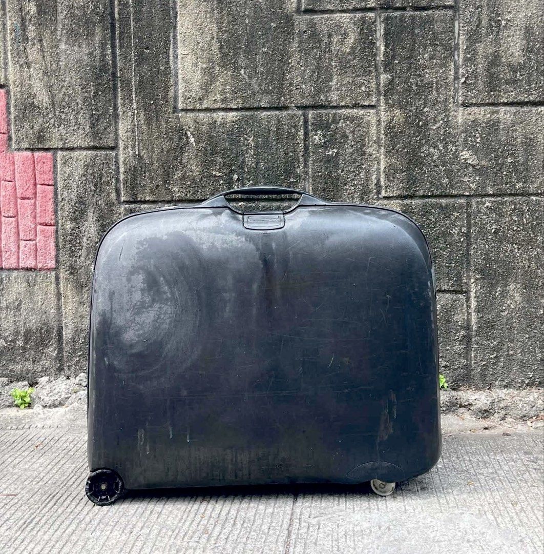 Samsonite Hard Shell Luggage Suitcase (Category: Luggage) located in Quezon City. Submitted by flyingmommie (Listing ID 1453084062, Image 1). Description: - Black Samsonite hard shell suitcase - Equipped with wheels and a retractable handle for easy mobility - Built-in combination lock for security - Includes an address tag slot - Shows minor scuffs and marks from regular use - Fully functional and ready for travel.