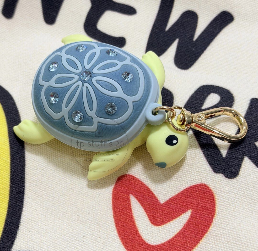 Bath & Body Works Sea Turtle PocketBac Holder (Category: Charms) located in Manila. Submitted by tpstuffs20 (Listing ID 1453107631, Image 1). Description: Limited Sea Turtle PocketBac Holder What it does: Keeps your favourite sanitizer close at hand. Why you'll love it: -Germs will never sea it comin' (but thanks to the sparkly gems, everyone else will)! -Convenient gold-tone clip attaches to your backpack, purse...or any bag, really! -Pairs with
