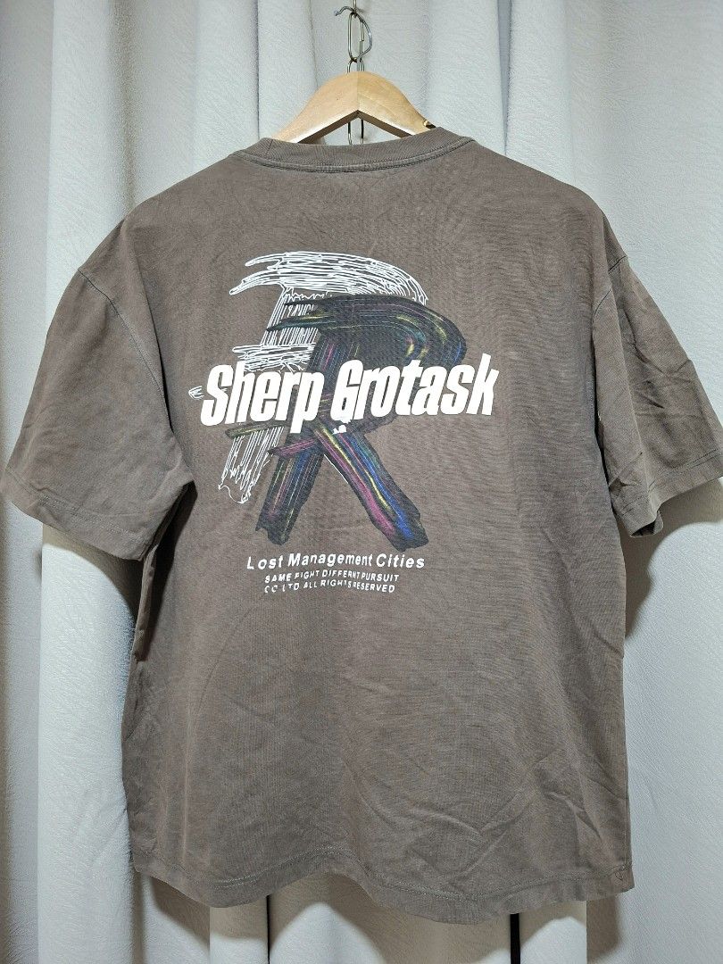 Sherp Grotask Graphic T-Shirt (Category: Tshirts & Polo Shirts ) located in Batangas. Submitted by sell_ph (Listing ID 1453051031, Image 2). Description: - Brand: Sherp Grotask - Color: Brown - Design: Graphic tee with 'Lost Management Cities' text on the back - Sleeves: Short sleeves - Neckline: Crew neck - Style: Casual wear.