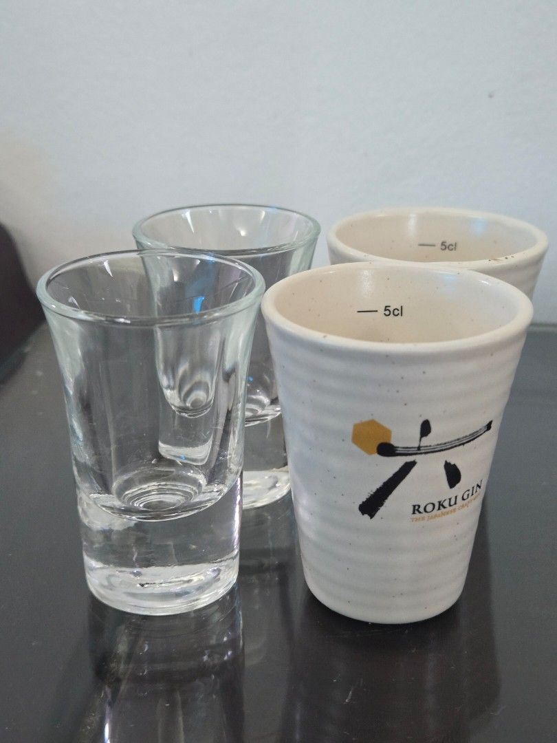 Shot Glasses (Category: Other Kitchenware & Tableware) located in Quezon City. Submitted by samcas (Listing ID 1453088232, Image 2). Description: Set of 4 shot glasses: 2 clear glass, 2 white ceramic Roku Gin glasses (5cl marked). Perfect for spirits. take all for only 200.