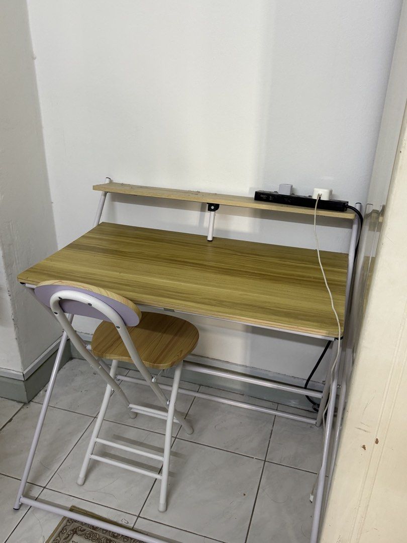 Study table (Category: Tables & Sets) located in Kuala Lumpur. Submitted by affhsykrh (Listing ID 1453087947, Image 2). Description: - Wood finish tabletop with sturdy metal frame - Folds flat for easy storage and portability - Perfect for small apartments, dorm rooms, or temporary workspaces - Includes a matching folding chair - Great for studying, working from home, or as a convenient side table.