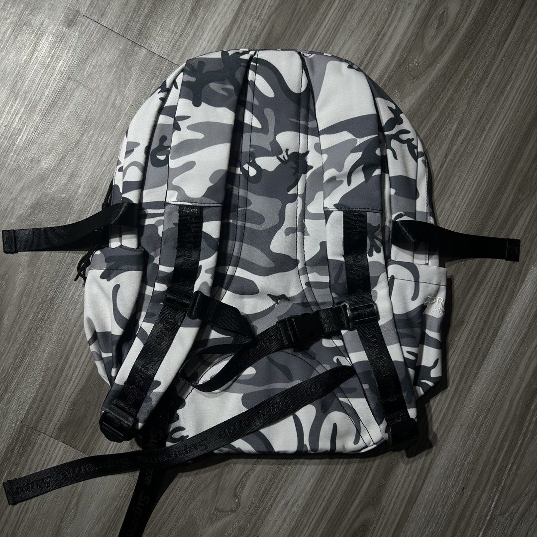 Supreme Camo Backpack CORDURA Fabric (Category: Backpacks) located in Manila. Submitted by pm302957949932 (Listing ID 1453178381, Image 3). Description: - Supreme backpack in stylish grey camo pattern. - Constructed with highly durable CORDURA fabric for long-lasting use. - Equipped with adjustable straps for a comfortable fit. - Includes convenient bungee cord detailing on the front for extra storage or style. - Offers ample space to carry all y