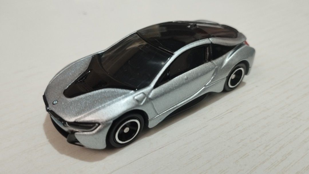 Tomica BMW i8 (Category: Vehicle & Diecast Models) located in Santa Cruz. Submitted by .rx-78-2 (Listing ID 1453117236, Image 1). Description: - Sleek silver BMW i8 toy car - Features stylish black accents on hood and roof - Tinted black windows for a cool look - Detailed wheels with silver rims and black centers - Ideal for car enthusiasts and young collectors.
