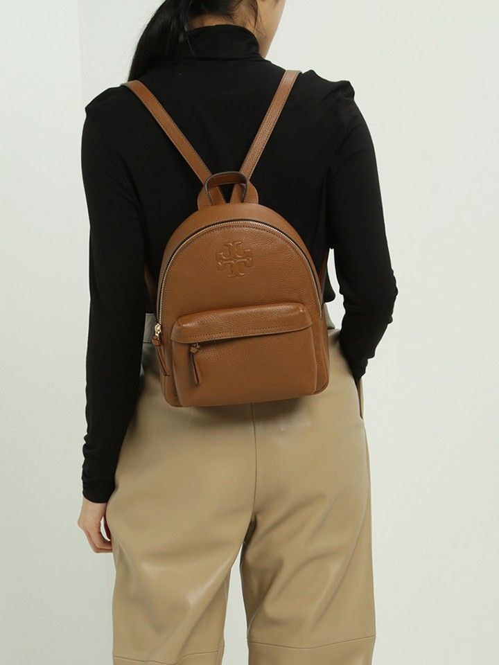 Tory Burch Thea Mini Leather classic tan Backpack (Category: Luxury Bags & Wallets) located in Cebu City. Submitted by westleygics18 (Listing ID 1453214676, Image 2). Description: - Excellent Condition - Color: Brown - Signature Tory Burch logo embossed on the front - Convenient front zip pocket - Adjustable straps for comfortable wear - Clean and well-maintained interior - Zippers function smoothly - Ideal for everyday use - Actual pics posted.