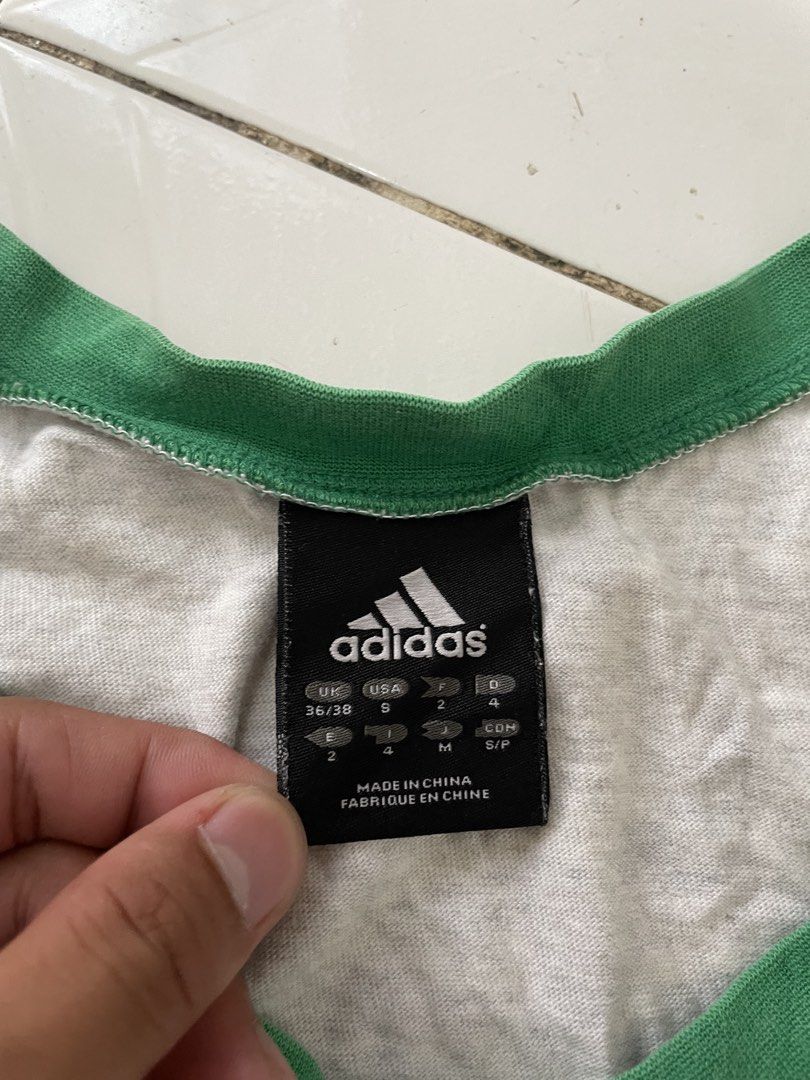Vintage Adidas Grey Ringer Tank Top (Category: Sleeveless) located in Siniloan. Submitted by rethr1ft (Listing ID 1453064003, Image 2). Description: - Grey Adidas tank top - Ringer trim detail - Features iconic Adidas logo in red, yellow, and green - Size: S - Made in China - Ideal for casual wear or workouts.