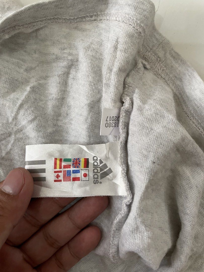 Vintage Adidas Grey Ringer Tank Top (Category: Sleeveless) located in Siniloan. Submitted by rethr1ft (Listing ID 1453064003, Image 3). Description: - Grey Adidas tank top - Ringer trim detail - Features iconic Adidas logo in red, yellow, and green - Size: S - Made in China - Ideal for casual wear or workouts.