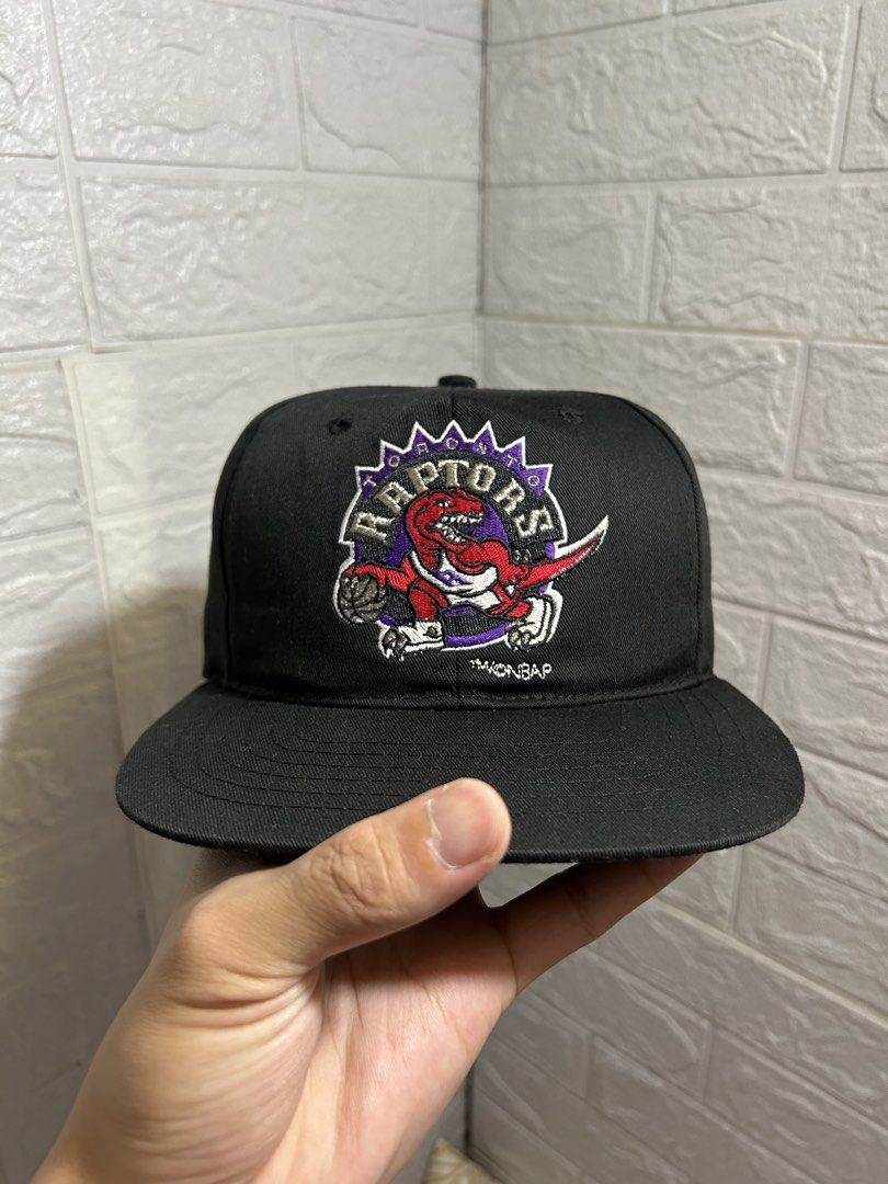 Vintage Toronto Raptors Starter NBA Snapback Cap (Category: Caps & Hats) located in Baguio. Submitted by don_ben (Listing ID 1451040016, Image 2). Description: - Classic Toronto Raptors snapback cap - Features the iconic Raptors logo on the front - Starter branding on the back - Made with a comfortable 65% polyester, 35% cotton blend - Adult size with an adjustable snap for a custom fit.