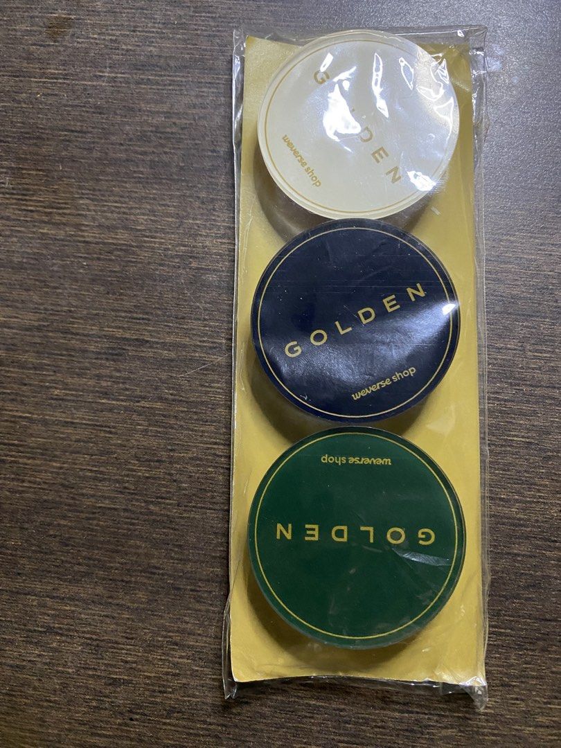 Weverse Shop Golden POB Griptok/Popsocket (Category: Mounts & Holders) located in Quezon City. Submitted by drei13_sniffles (Listing ID 1453224108, Image 2). Description: - Golden POB Griptock or Popsocket - All stickers say 'GOLDEN' - Colors: White, Dark Blue, Dark Green - Like new, still in original packaging - rfs: need funds for Vet bills - 150 each; 400 if bought as set + sf - never used or opened .