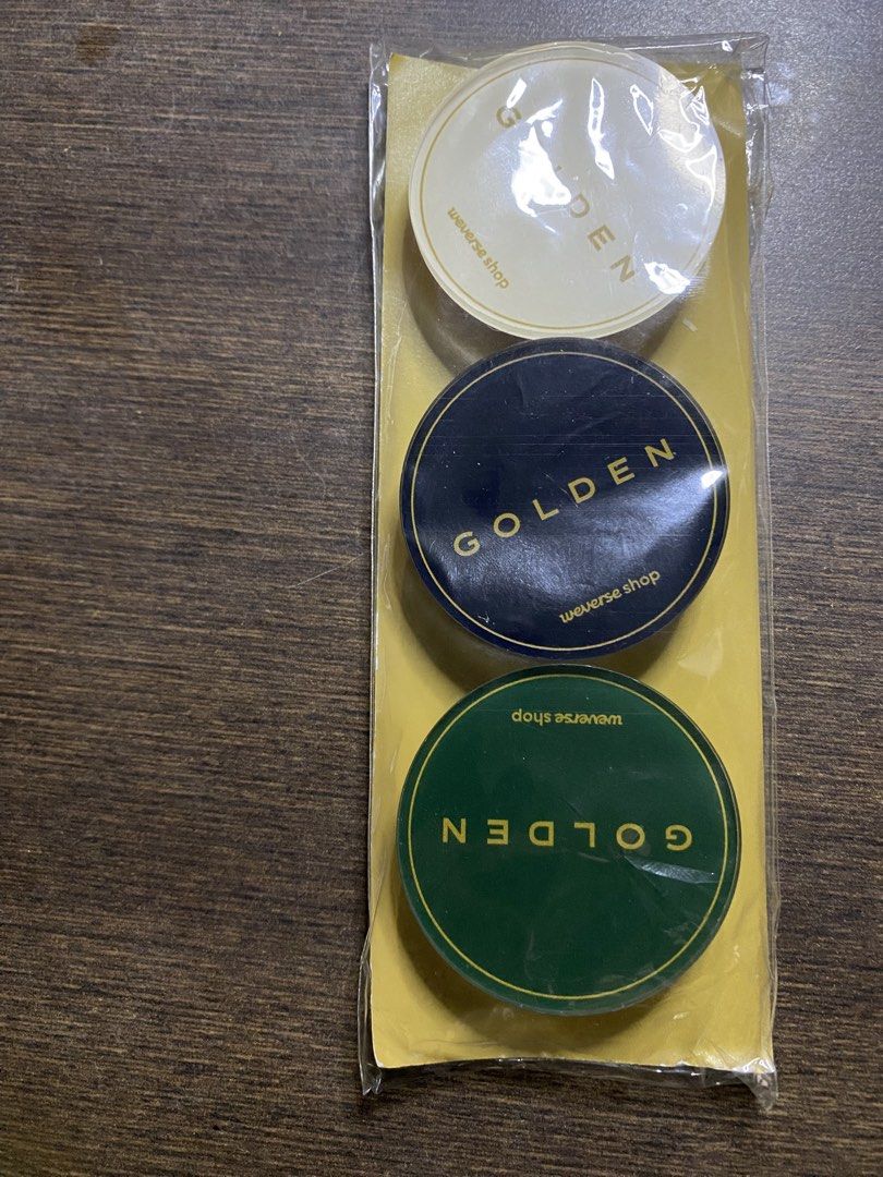 Weverse Shop Golden POB Griptok/Popsocket (Category: Mounts & Holders) located in Quezon City. Submitted by drei13_sniffles (Listing ID 1453224108, Image 1). Description: - Golden POB Griptock or Popsocket - All stickers say 'GOLDEN' - Colors: White, Dark Blue, Dark Green - Like new, still in original packaging - rfs: need funds for Vet bills - 150 each; 400 if bought as set + sf - never used or opened .
