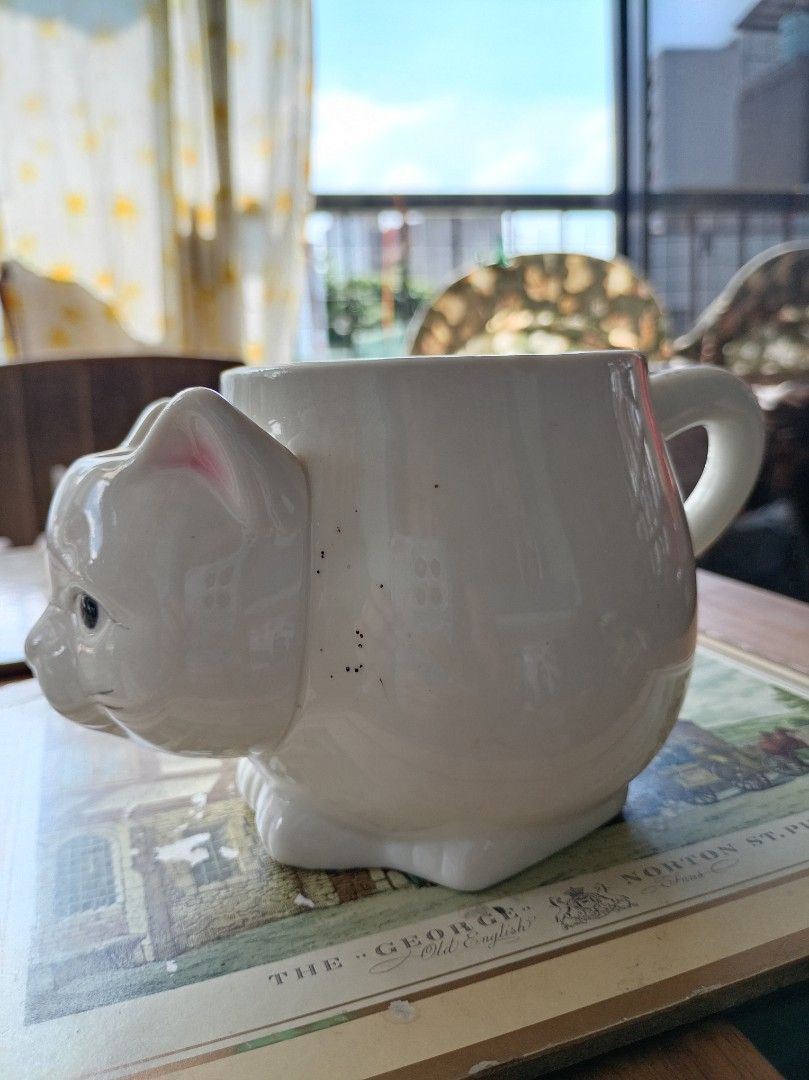 White Ceramic Cat Mug with Handle (Category: Coffee & Tea Tableware) located in Makati City. Submitted by meowmyella (Listing ID 1453060167, Image 2). Description: - Adorable white ceramic mug shaped like a cat. - Features a convenient side handle. - Ideal for your morning coffee or tea. - A fun and charming gift for any cat lover. Kindly send DM for more details.