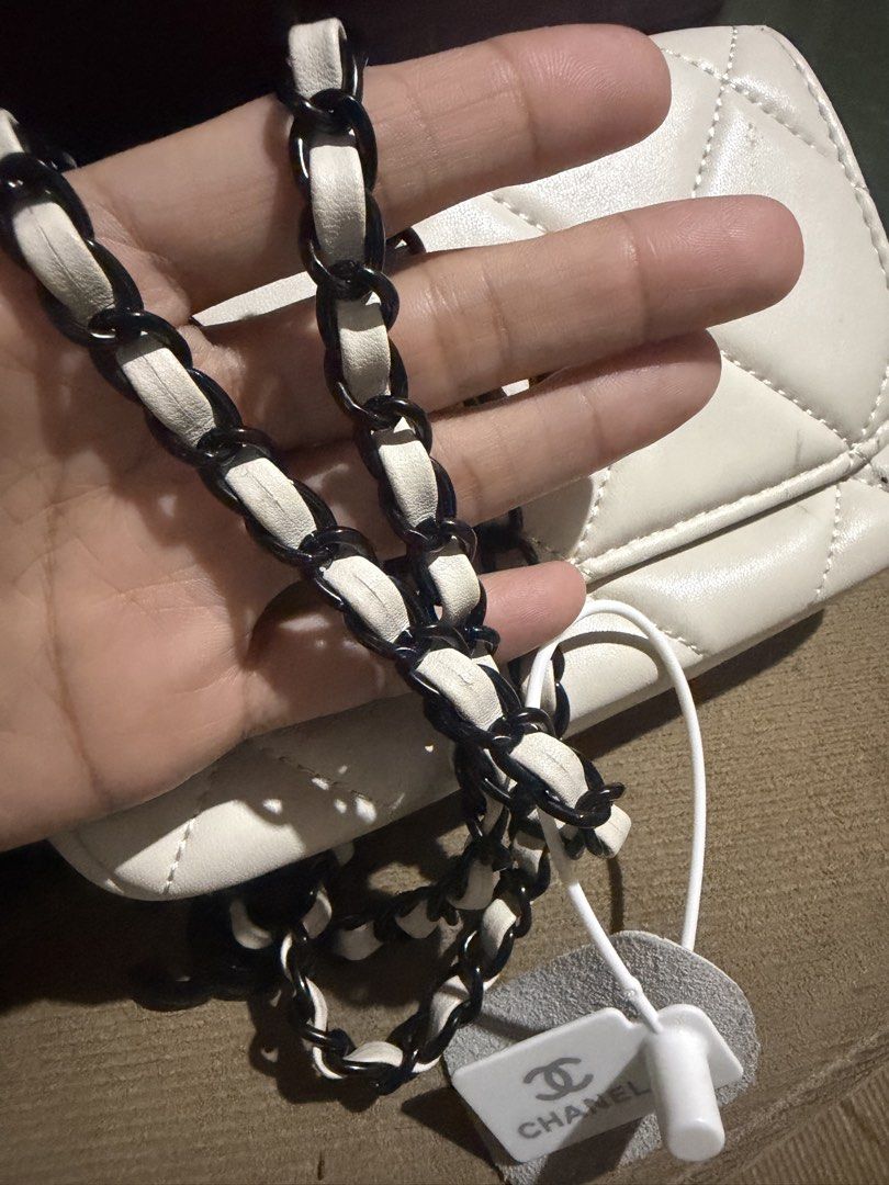White Quilted Chanel Flap Bag with Chain Strap with serial (Category: Luxury Bags & Wallets) located in San Fernando. Submitted by japanvintageaccessories (Listing ID 1453139263, Image 3). Description: - White quilted flap bag - Iconic black Chanel logo - Black and white chain strap - Includes Chanel charm - Interior small compartment - Secure snap button closure - Ideal for carrying essentials.