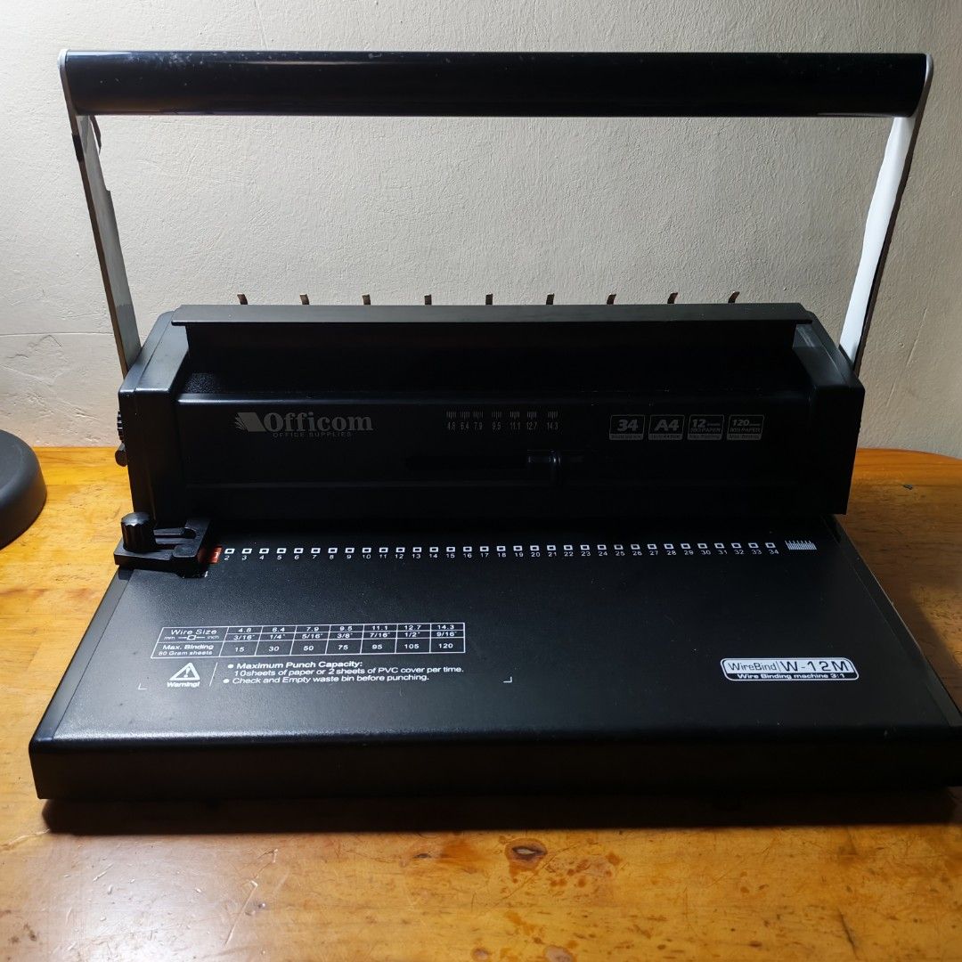 Wire binding machine (Category: Craft Supplies & Tools) located in Mandaluyong City. Submitted by kp_merch (Listing ID 1453203075, Image 3). Description: A4 size wire binding machine Max punching capacity: 12 sheets Max binding capacity: 140 sheets 34 punching holes Included: 14 unused binding rings Oslo papers Issues: Paint is peeling off in the handle (see last 2 photos).