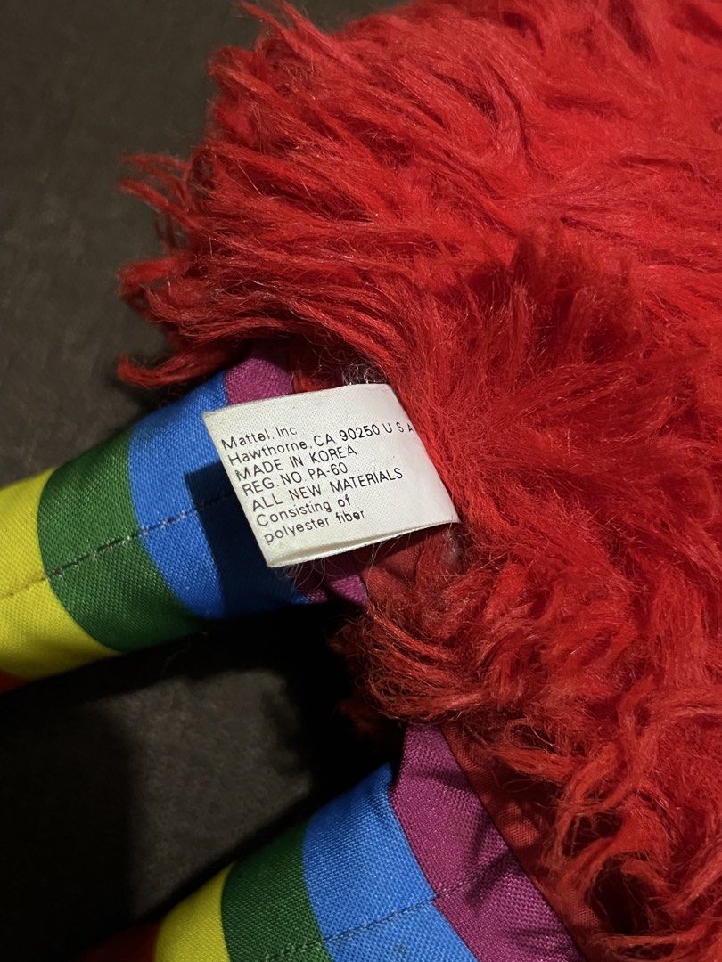 1983 Rainbow Brite Romeo Red Sprite Plush Toy (Category: Plushies & Soft Toys) located in Taguig. Submitted by goofysofties (Listing ID 1454883334, Image 3). Description: - Vintage red plush toy from Hallmark Cards - Features fuzzy red body and colorful rainbow striped legs - Red feet with black dot accents - Two yellow stars adorn its head - Manufactured in Korea by Mattel Inc. - A delightful collectible item for enthusiasts.