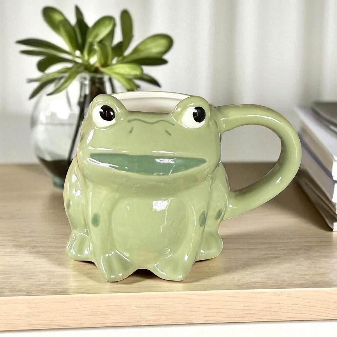 🐸 Cute Frog Ceramic Mug 🐸 (Category: Coffee & Tea Tableware) located in Caloocan City. Submitted by rabbithole2026 (Listing ID 1454813510, Image 1). Description: Selling this adorable frog-shaped ceramic mug! Perfect for coffee, tea, hot chocolate, or as a cute desk and kitchen decoration. ✨ Glossy ceramic finish ✨ Unique frog design ✨ Great for collectors and frog lovers ✨ Good condition.