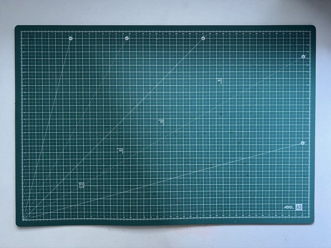 ABEL A3 Cutting Mat - Green (Category: Craft Supplies & Tools) located in Manila. Submitted by chesbedumb (Listing ID 1454834042, Image 2). Description: - Green A3 cutting mat - Features grid lines and measurements for precise cutting - Includes markings for A4, A5, and business cards - Ideal for crafts, sewing, and various projects - Protects your work surfaces - Easy to store - Has minor cutting marks but not deep.
