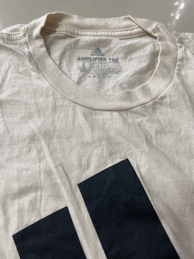 Adidas Amplifier Tee T-shirt XS/TP (Category: Tshirts & Polo Shirts ) located in Cavite. Submitted by 064wiiic (Listing ID 1454783323, Image 2). Description: - Adidas Amplifier Tee - Color: Cream/Beige - Size: XS/TP - Classic black Adidas logo design - Ideal for casual and everyday outfits - Simple and iconic style.