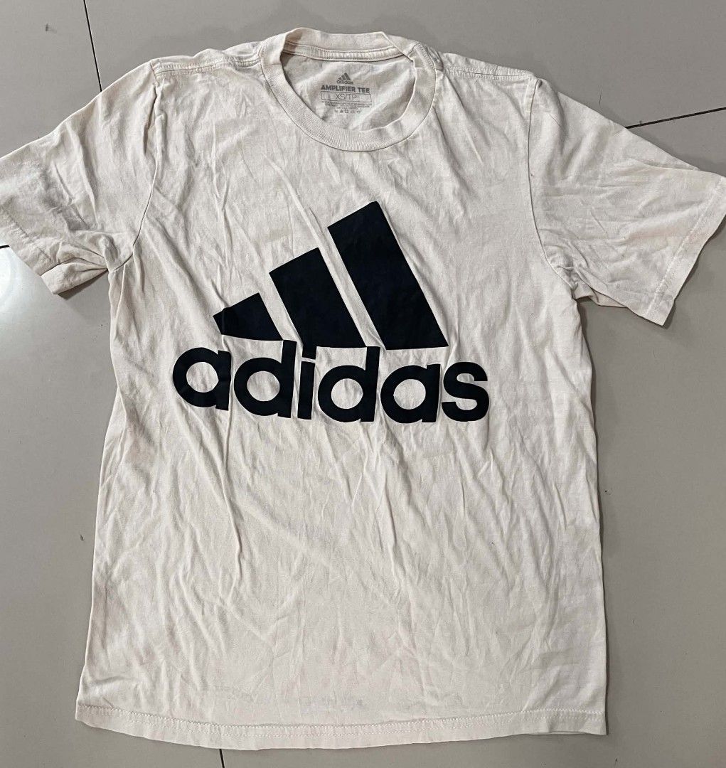 Adidas Amplifier Tee T-shirt XS/TP (Category: Tshirts & Polo Shirts ) located in Cavite. Submitted by 064wiiic (Listing ID 1454783323, Image 1). Description: - Adidas Amplifier Tee - Color: Cream/Beige - Size: XS/TP - Classic black Adidas logo design - Ideal for casual and everyday outfits - Simple and iconic style.