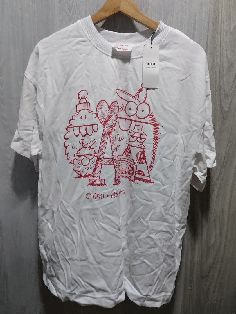 Ami Paris x Kevin Lyons t-shirt (Category: Luxury Apparel) located in Bacoor. Submitted by nigel_008 (Listing ID 1454911699, Image 1). Description: This white crewneck t-shirt from the Ami Paris x Kevin Lyons collaboration features a playful red graphic print..