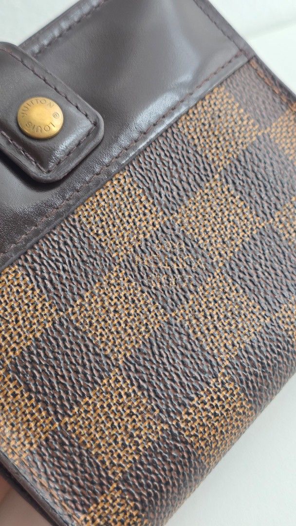 Authentic Louis Vuitton Damier Ebene Small Wallet (Category: Luxury Bags & Wallets) located in Paranaque City. Submitted by lacelacelace (Listing ID 1454776651, Image 3). Description: - Authentic Louis Vuitton wallet - Damier Ebene canvas in brown checkered pattern - Dark brown leather trim - Secure snap button closure - Multiple interior compartments for organization - Zippered pocket for coins or small items - Compact size, perfect for pockets 
