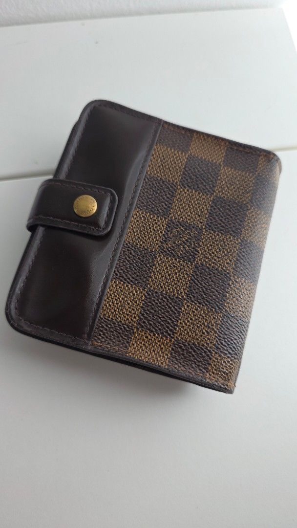 Authentic Louis Vuitton Damier Ebene Small Wallet (Category: Luxury Bags & Wallets) located in Paranaque City. Submitted by lacelacelace (Listing ID 1454776651, Image 1). Description: - Authentic Louis Vuitton wallet - Damier Ebene canvas in brown checkered pattern - Dark brown leather trim - Secure snap button closure - Multiple interior compartments for organization - Zippered pocket for coins or small items - Compact size, perfect for pockets 