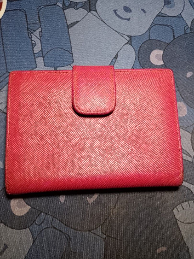 Authentic Prada Saffiano Leather Wallet Pink (Category: Luxury Bags & Wallets) located in Manila. Submitted by anvicnicajeff (Listing ID 1454942416, Image 2). Description: - Authentic Prada wallet - Pink Saffiano leather - Colour: Hibiscus - Saffiano Leather with Gold-Tone Hardware - Snap Button Closure on 2 sides - 4 card slots & 1 bill compartment - 1 rear coin compartment - Bi-fold design with snap closure - Shows some signs of wear (edges & i