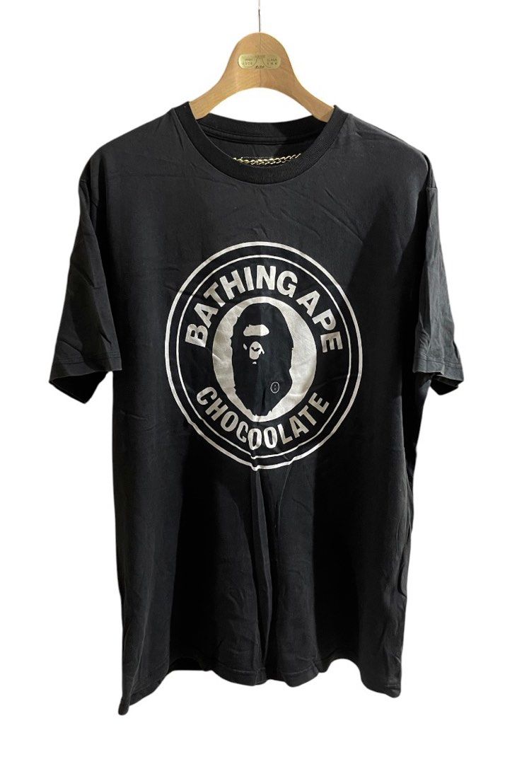 BAPE x Chocolate Tee Unisex (Category: Tshirts & Polo Shirts ) located in San Pedro. Submitted by lifebeginsaftercoff33 (Listing ID 1454798125, Image 1). Description: - Bathing Ape x Chocolate collaboration t-shirt Unisex - Features iconic Ape Head logo with 'Bathing Ape Chocolate' text - Classic crew neck, short sleeves - Perfect for streetwear enthusiasts - Very soft comfy fabric - Cotton - Dimes: 21 x 28 in - Cut tag - Please check the last tw